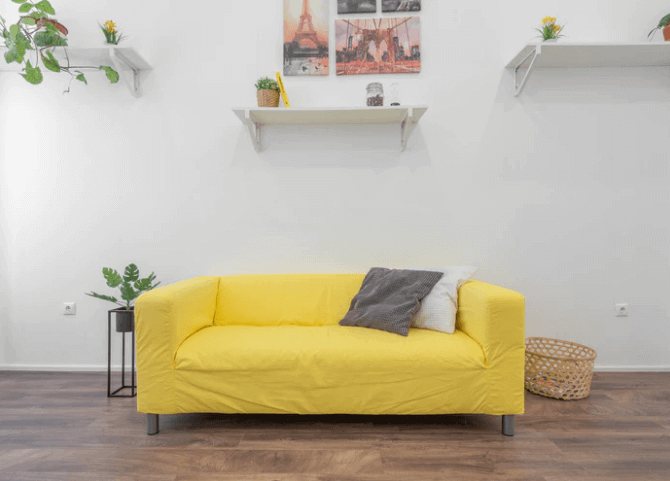 Yellow Sofa With Shelves High Around It.